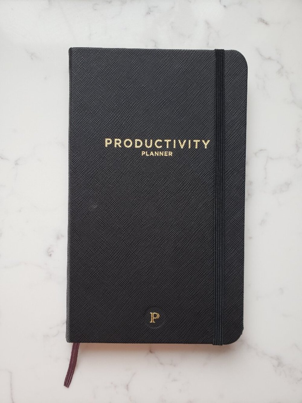 black hardcover Productivity Planner, daily weekly goal organizer